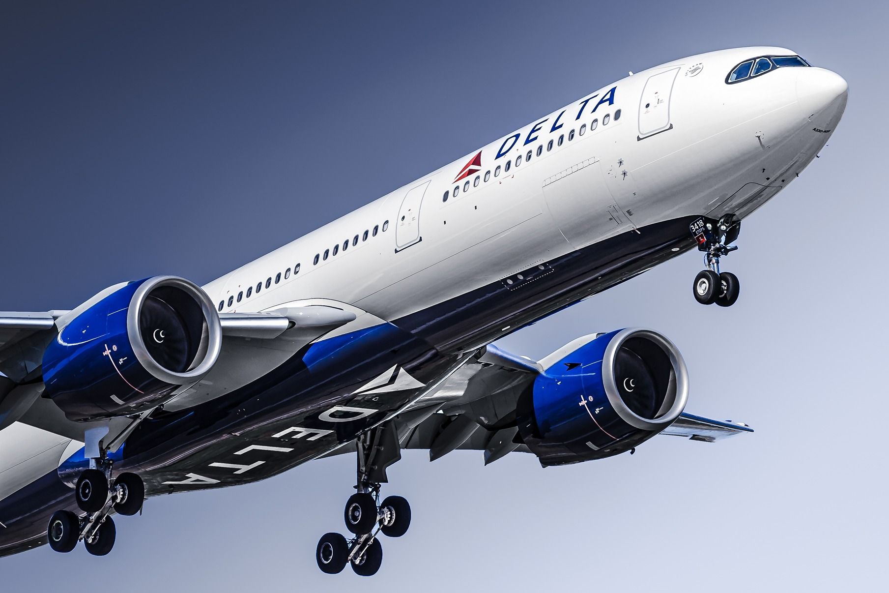 A Delta Air Lines Airbus A330-900 flying in the sky.