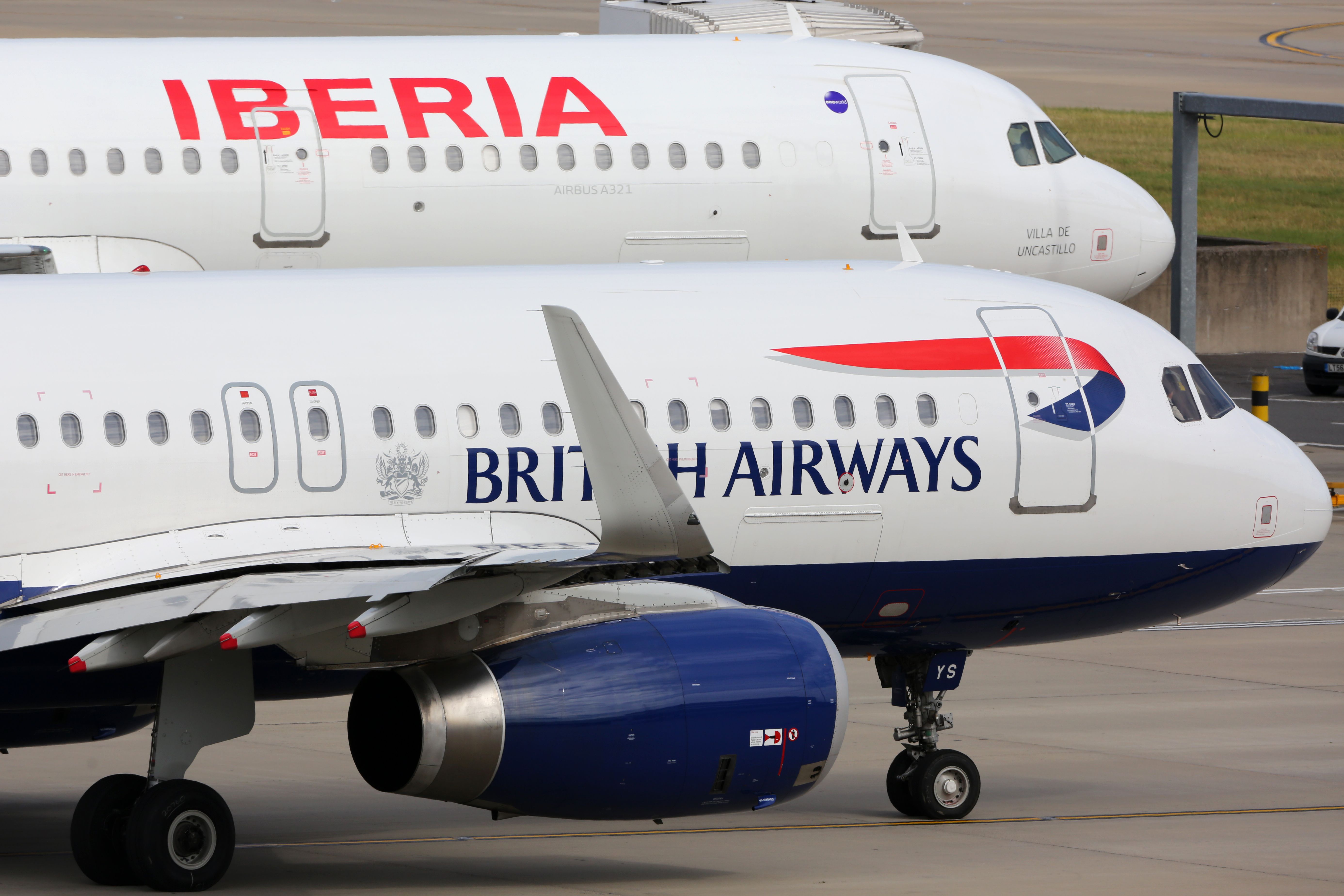 A Closeup of A British Airways Airbus A320 Parked Next To An Iberia Airbus A321.