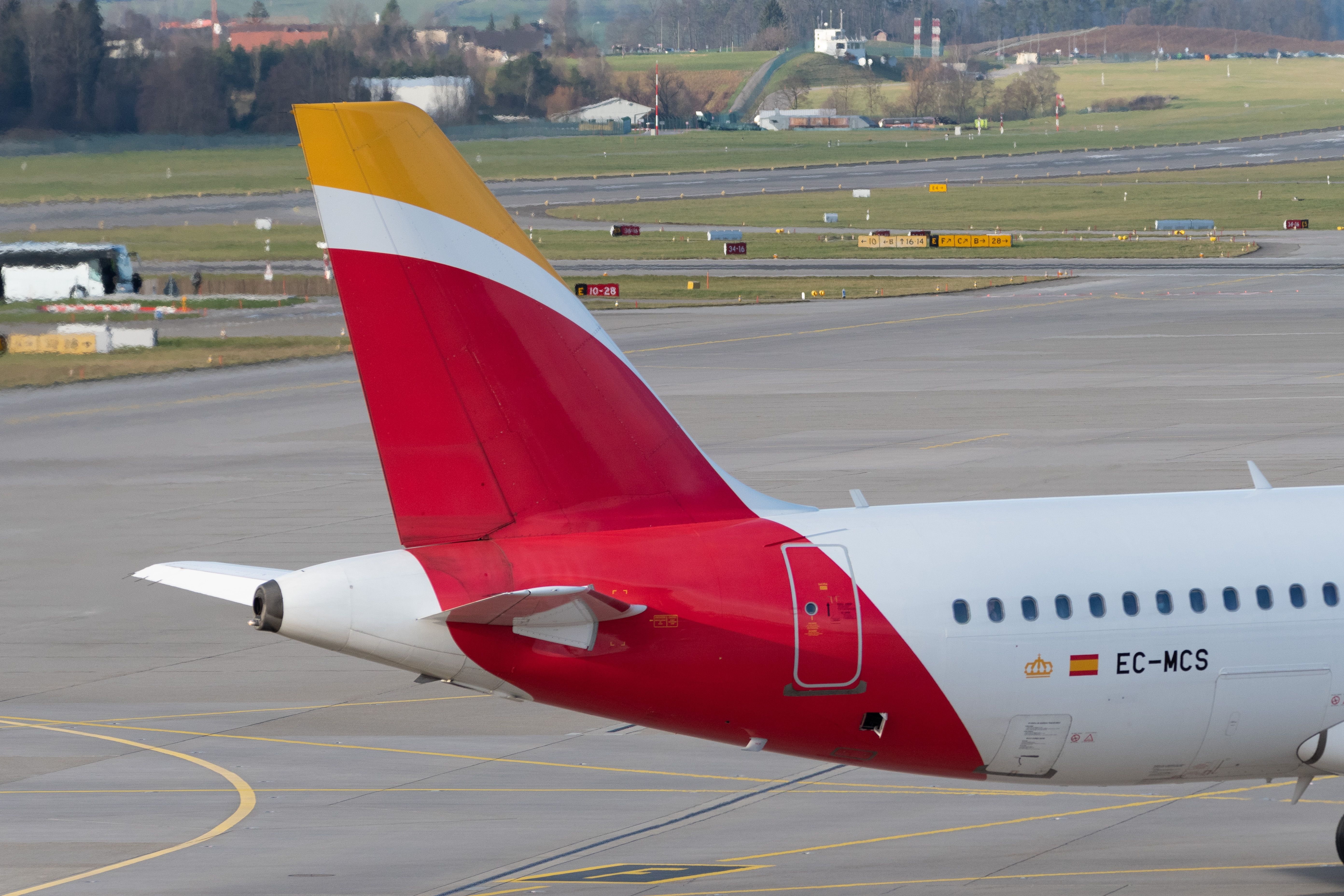 Tail of an Iberia Airbus A320 aircraft at Zurich Airport ZRH shutterstock_2286341341