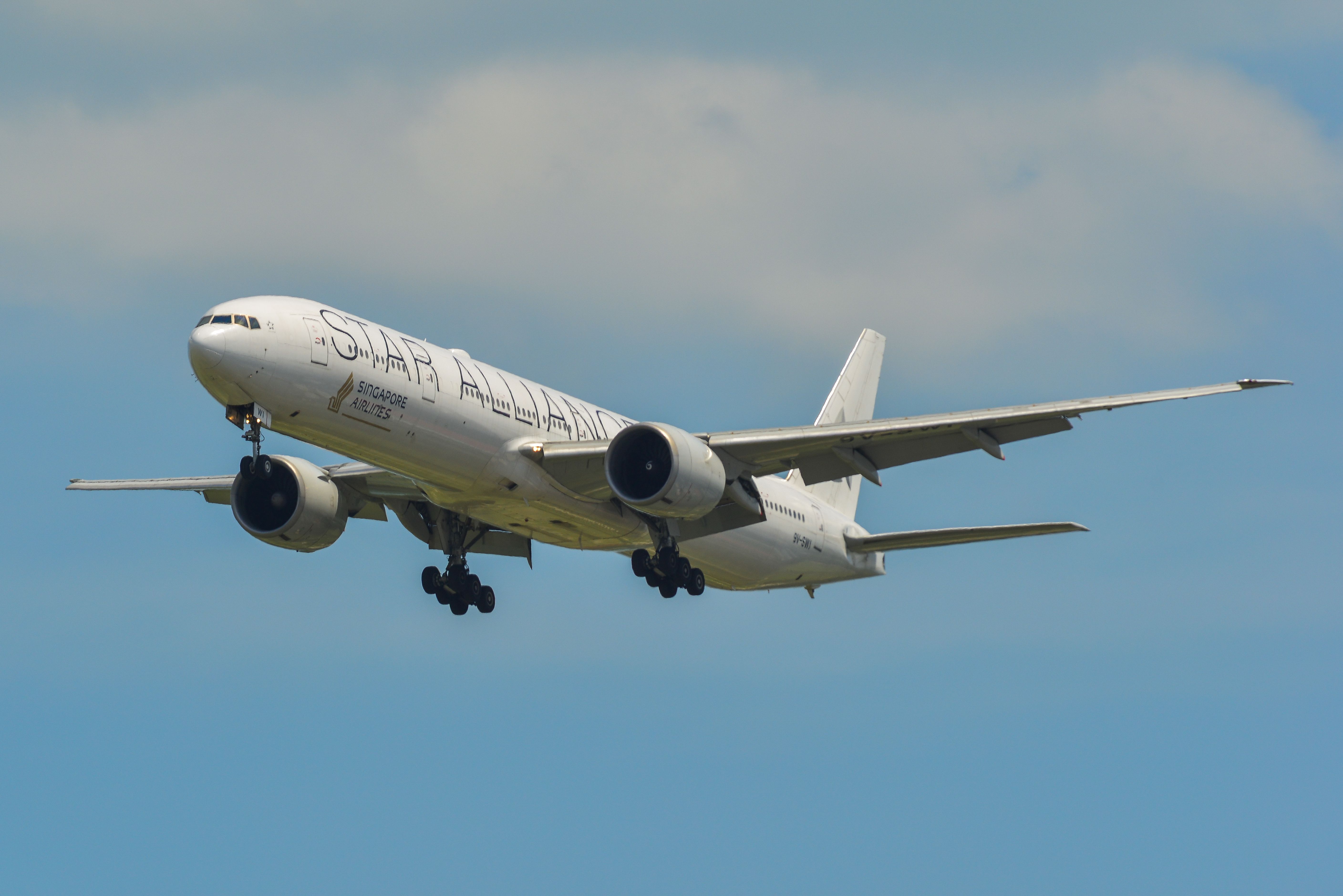 Singapore Airlines Boeing 777-300ER with the Star Alliance livery landing at Singapore Changi Airport SIN shutterstock_1466738315