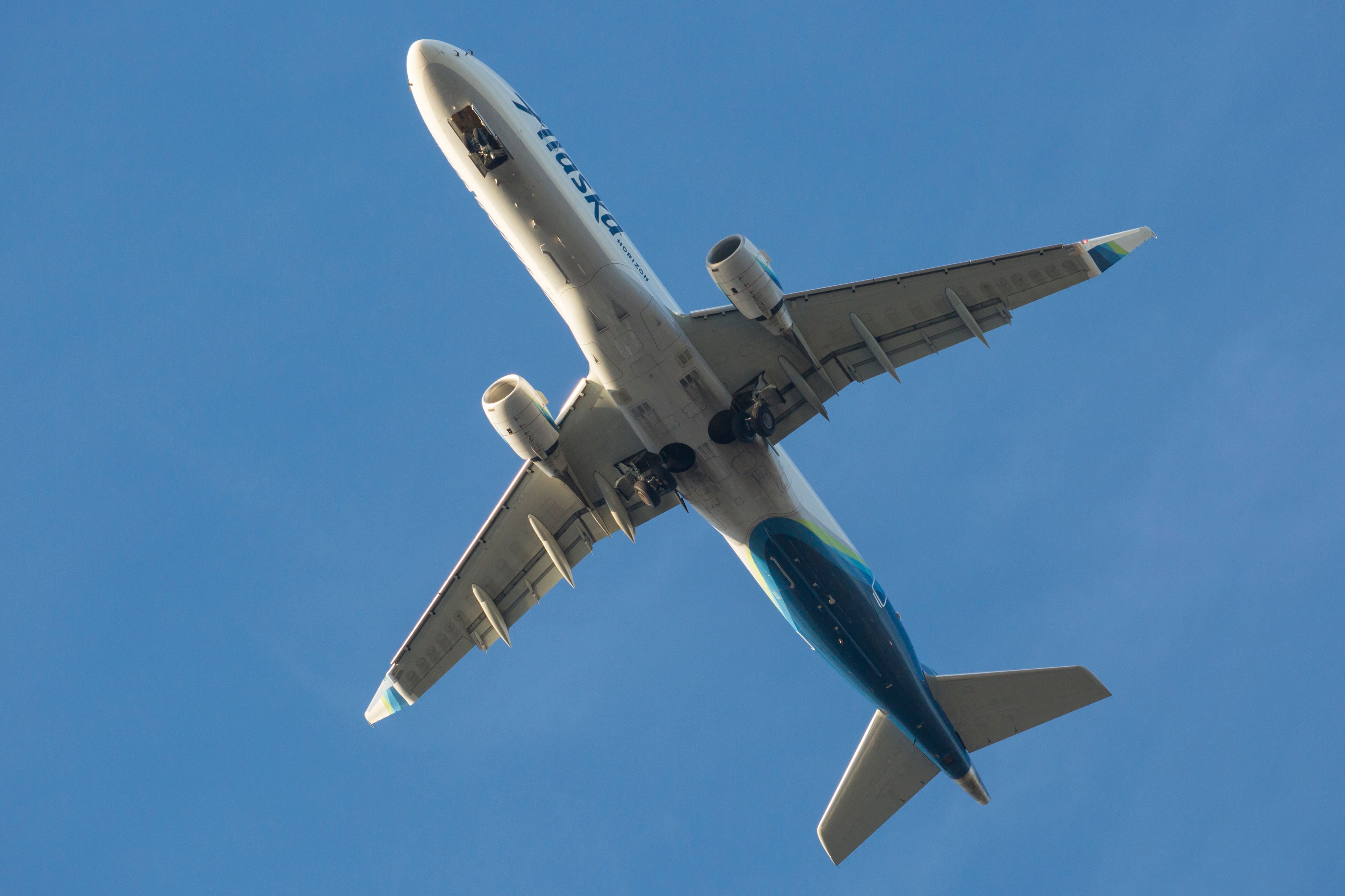 An Alaska Airlines Horizon Air Embraer E175 flies over Boeing Field after departing from SEATAC.