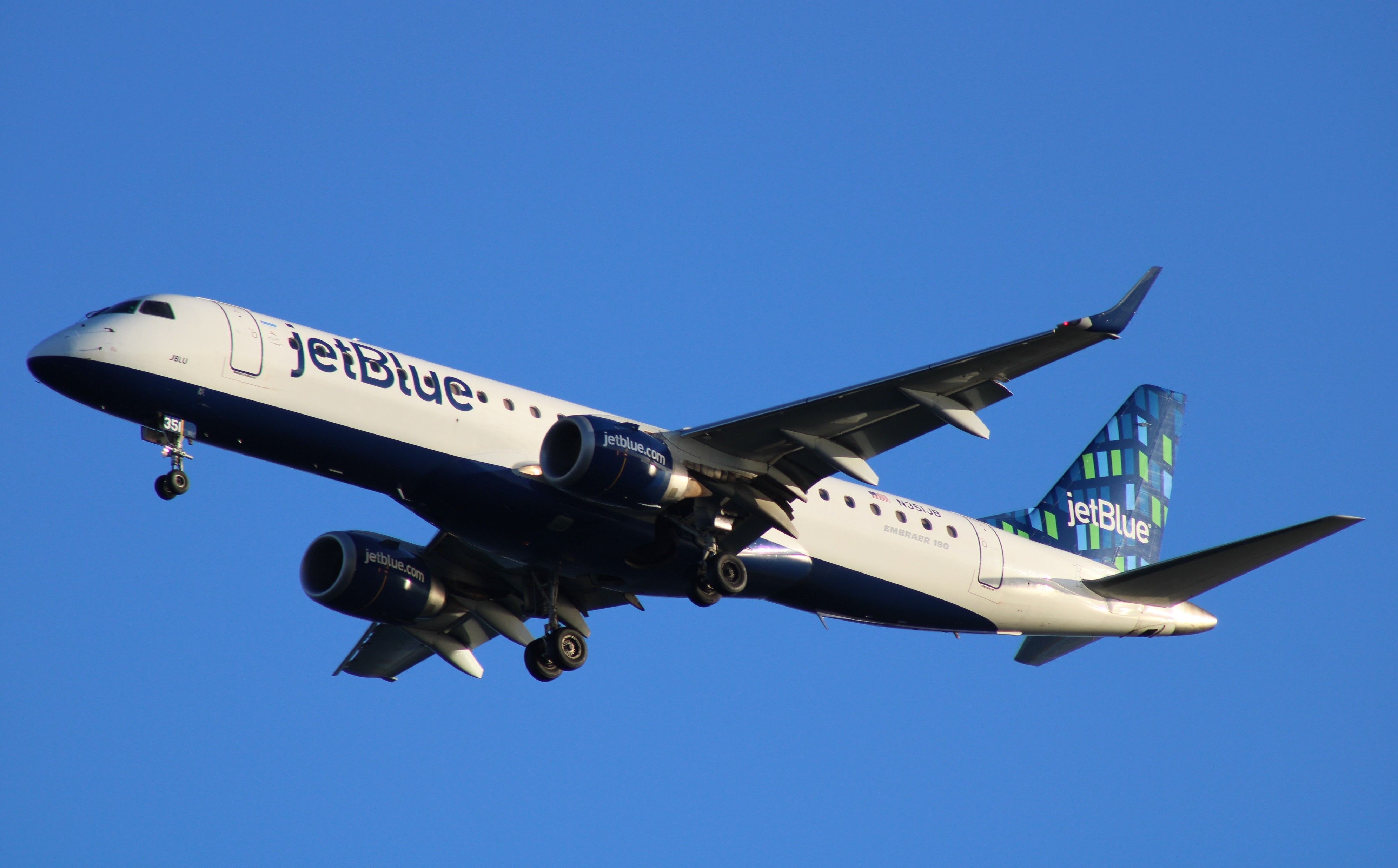 A JetBlue Airbus A220 flying in the sky