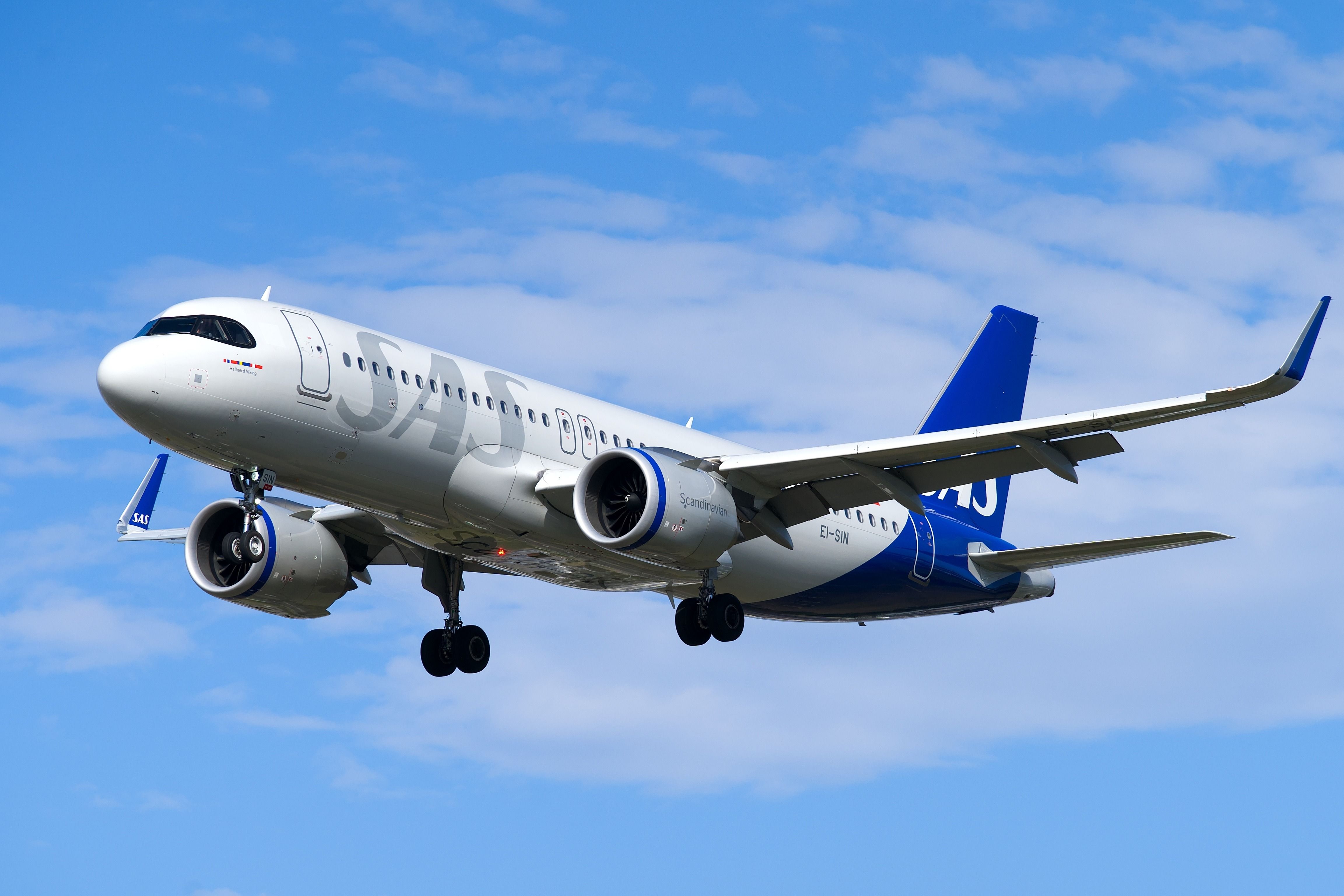 SAS Scandinavian Airlines Airbus A320 landing with a blue sky. London - 29th August 2024
