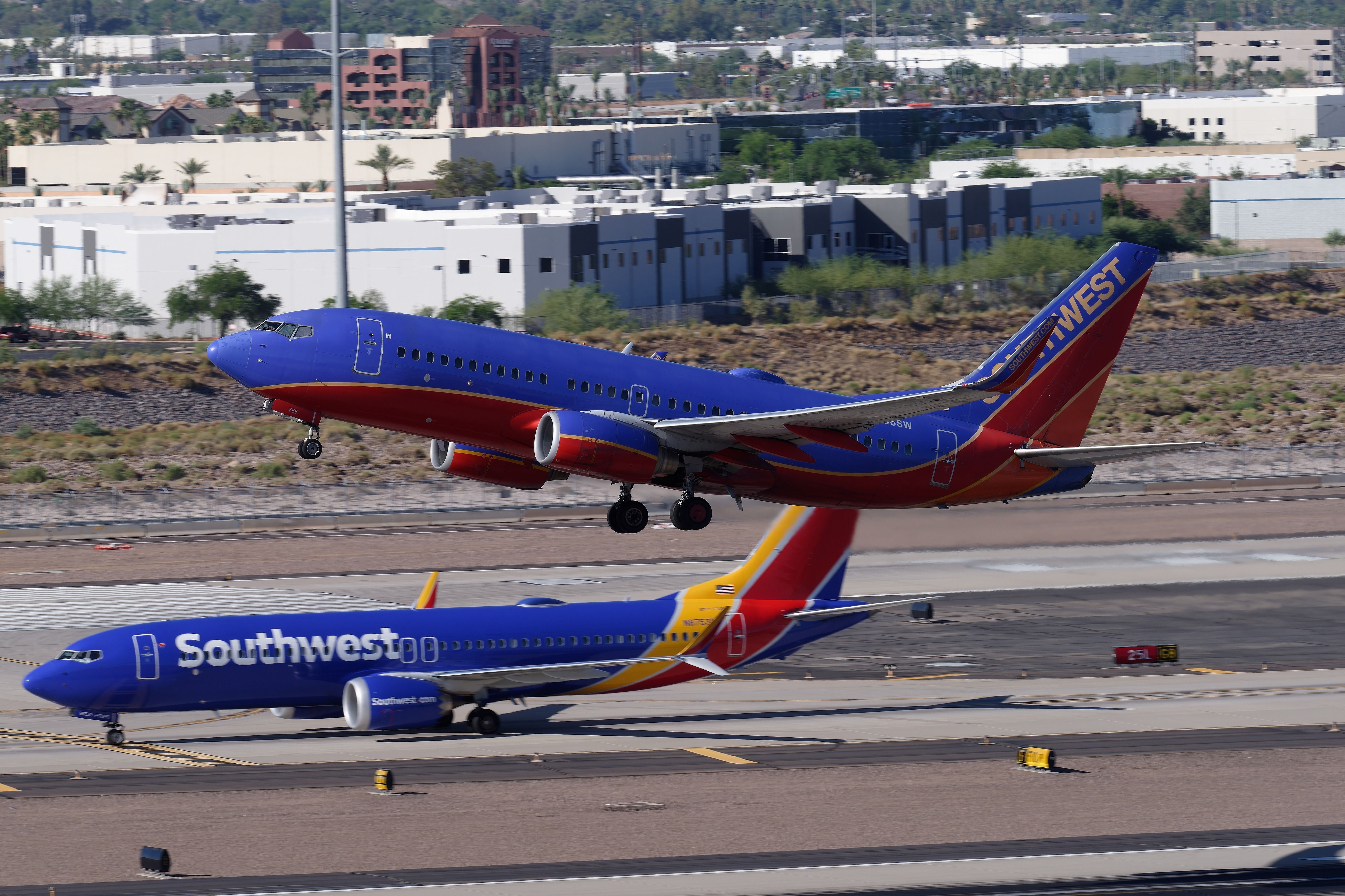 Two Southwest Airlines Boeing 737 aircraft at PHX shutterstock_2314329285