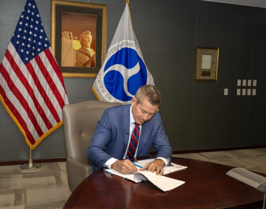 Sean Duffy signing a memorandum