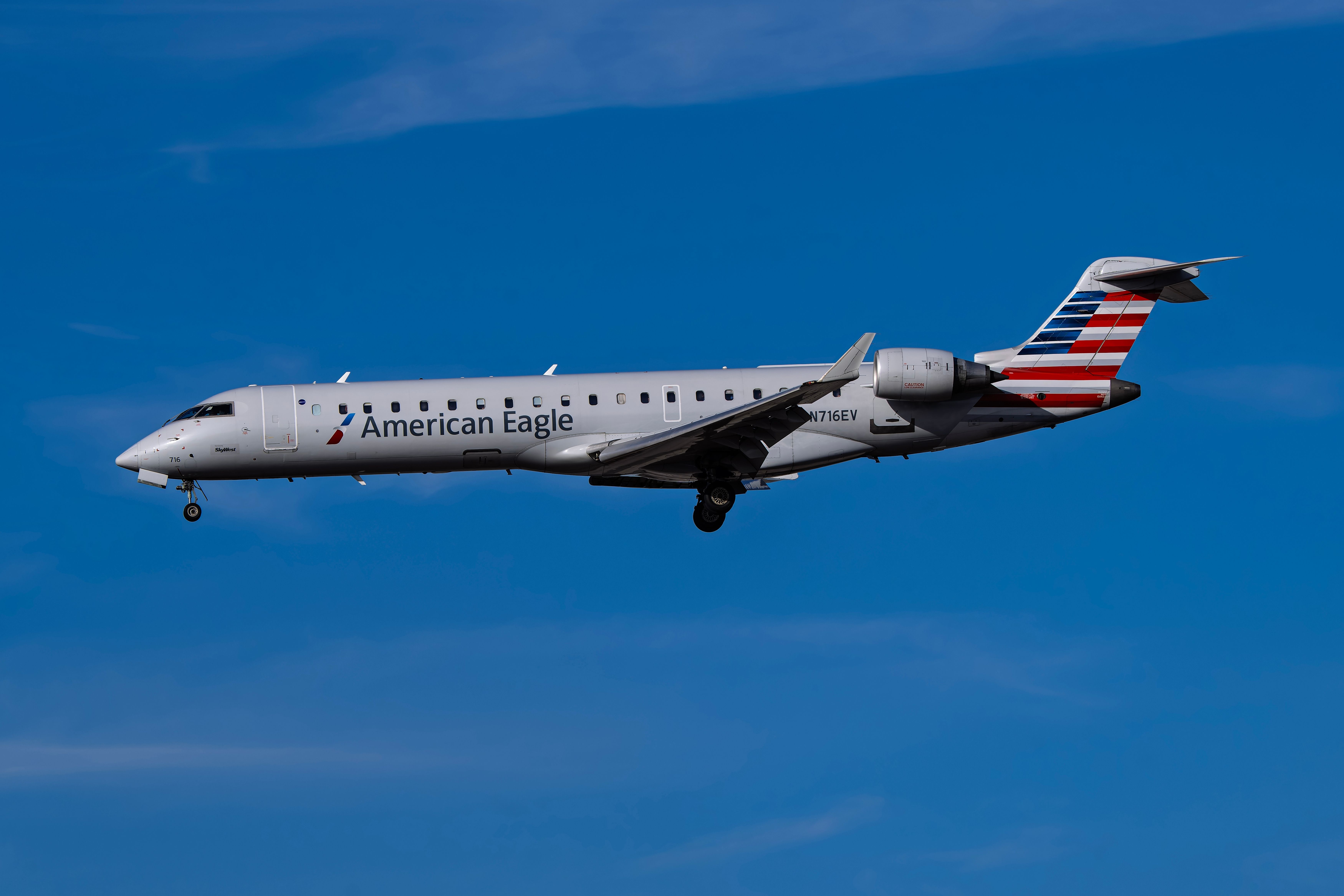 American Eagle Bombardier CRJ700 landing at Phoenix Sky Harbor International Airport PHX shutterstock_2566654021