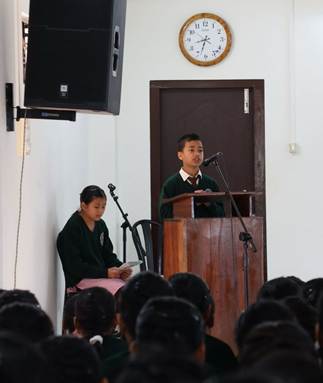 A group of people standing in front of a podiumAI-generated content may be incorrect.