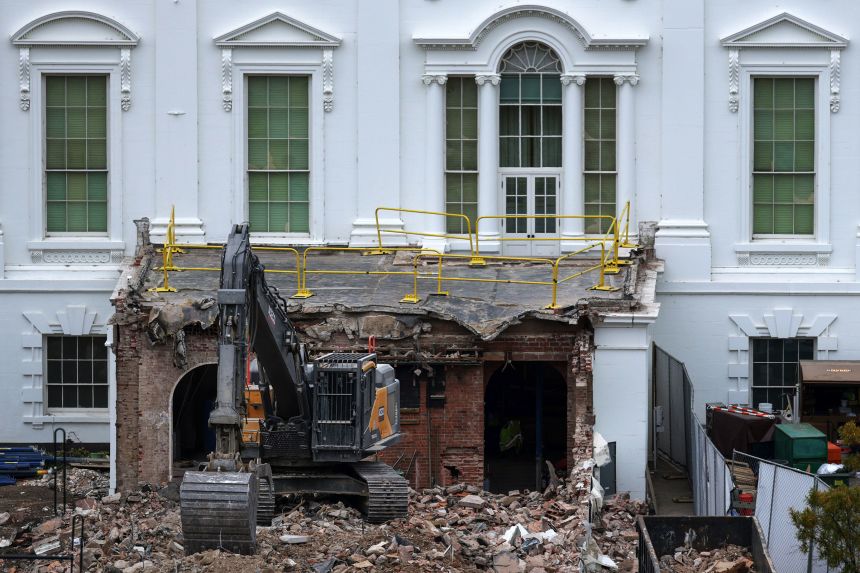 An excavator sits on the rubble after the East Wing of the White House was demolished on October 28, 2025.