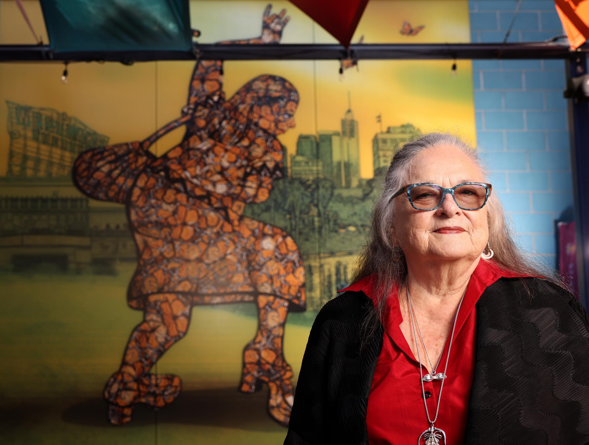 Judy Baca poses in front of "La Salsera," a large-scale artwork at LA Plaza de Cultura y Artes in Los Angeles.
