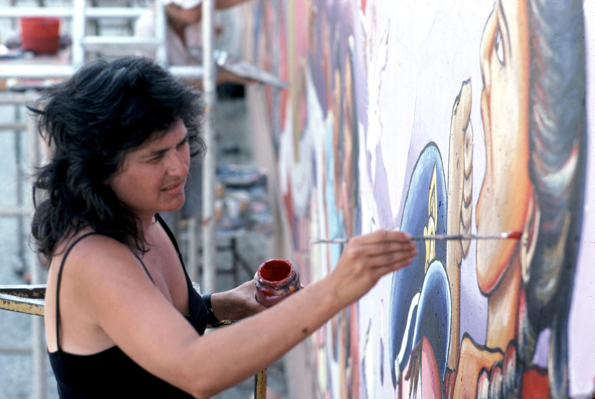 Judy Baca painting "The Great Wall of Los Angeles" in 1983.
