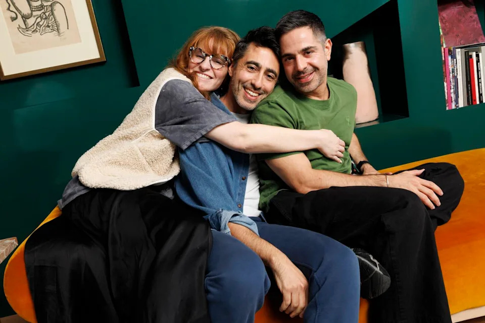 Three friends sit side by side.