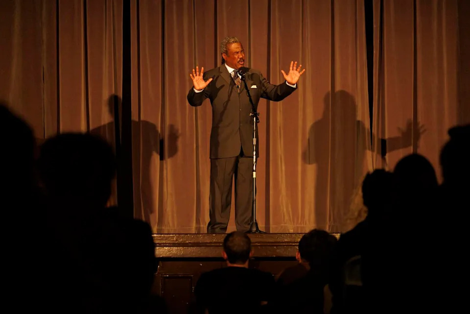 A man performs a speech onstage