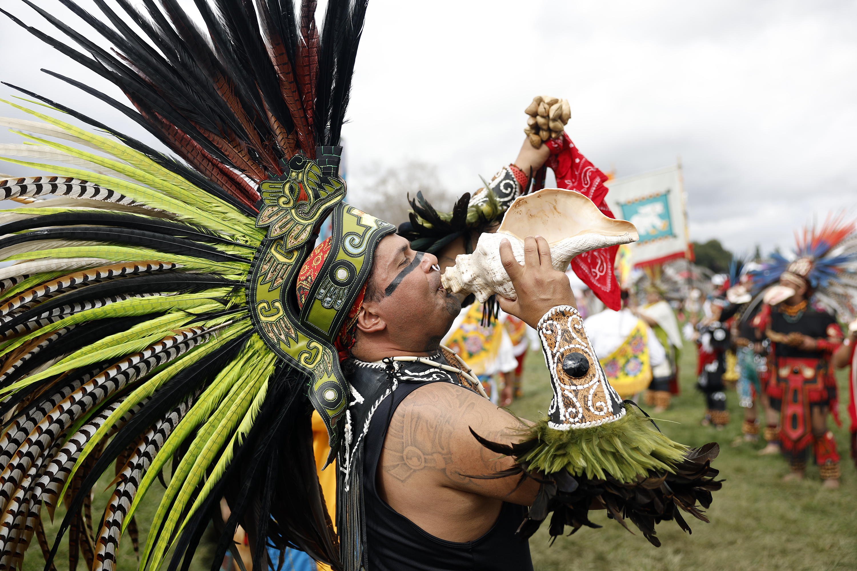 Malinalcoatl, Israel Zabala, blows the conch shell trumpet quiquiztli as...