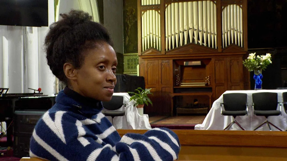 Fiona Paquette of the East London School of Music with the Nelson organ saved from a church in County Durham. She has short black hair and wears a blue and white striped jumper.
