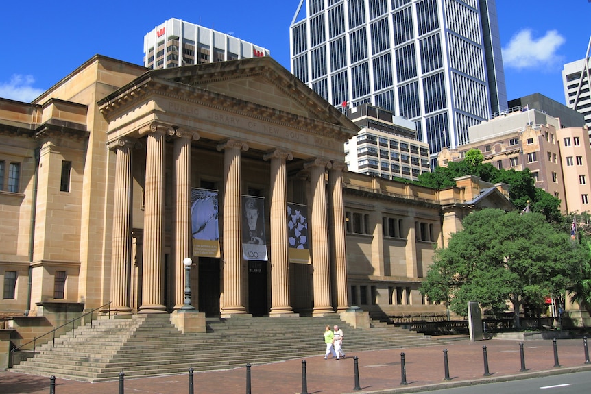 a large sandstone building with columns out the front seen from outside