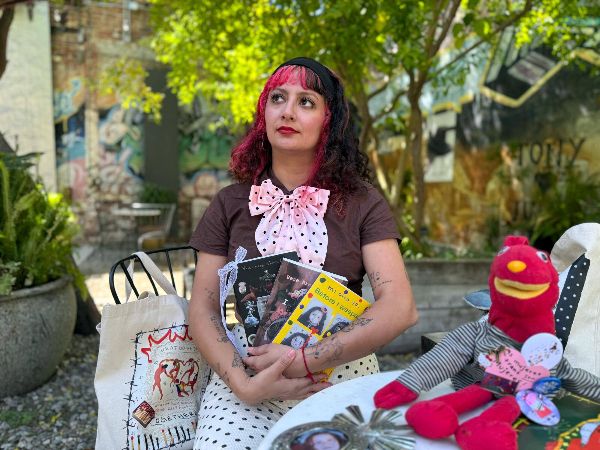 Social media poet Vianney Harelly holds her three self-published books at Hauser and Wirth.