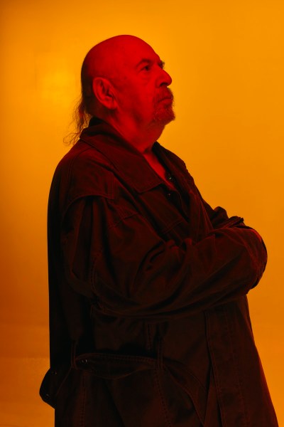 Portrait of Vladimir Tsesler against an orange background. 