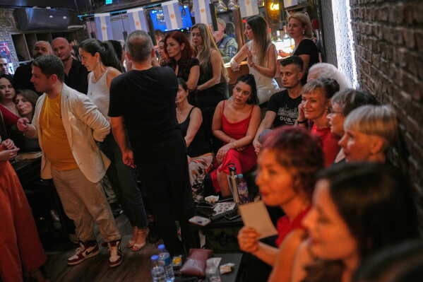 Tango enthusiasts sit and watch others dance during a milonga session at La Cumparsita in Istanbul, Turkey, Tuesday, Jan. 27, 2026. (AP Photo/Francisco Seco)