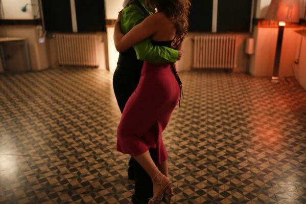 Turkish tango enthusiasts Gonca Cetin and Guralp Diner dance during a milonga evening session at Zeytuna in Istanbul, Turkey, Thursday, May 21, 2026. (AP Photo/Francisco Seco)