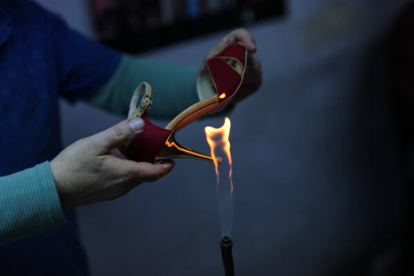An employee works on crafting tango dance shoes at Necmi Usta's workshop in Istanbul. (AP Photo/Francisco Seco)