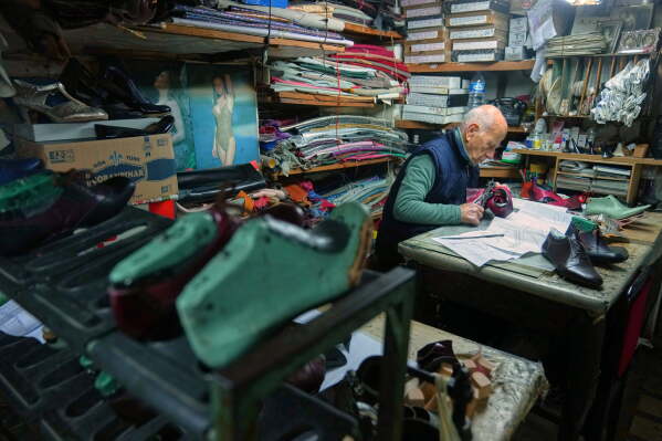 Dance shoe craftsman Ercan Umay works at his workshop in Istanbul, Turkey, Tuesday, Jan. 20, 2026. (AP Photo/Francisco Seco)