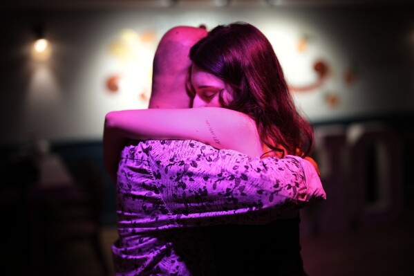 A tattoo in Spanish reading "There is no law" adorns the arm of a woman dancing during a tango milonga session at Soho Tangoport in Istanbul, Turkey, Thursday, Jan. 29, 2026. (AP Photo/Francisco Seco)