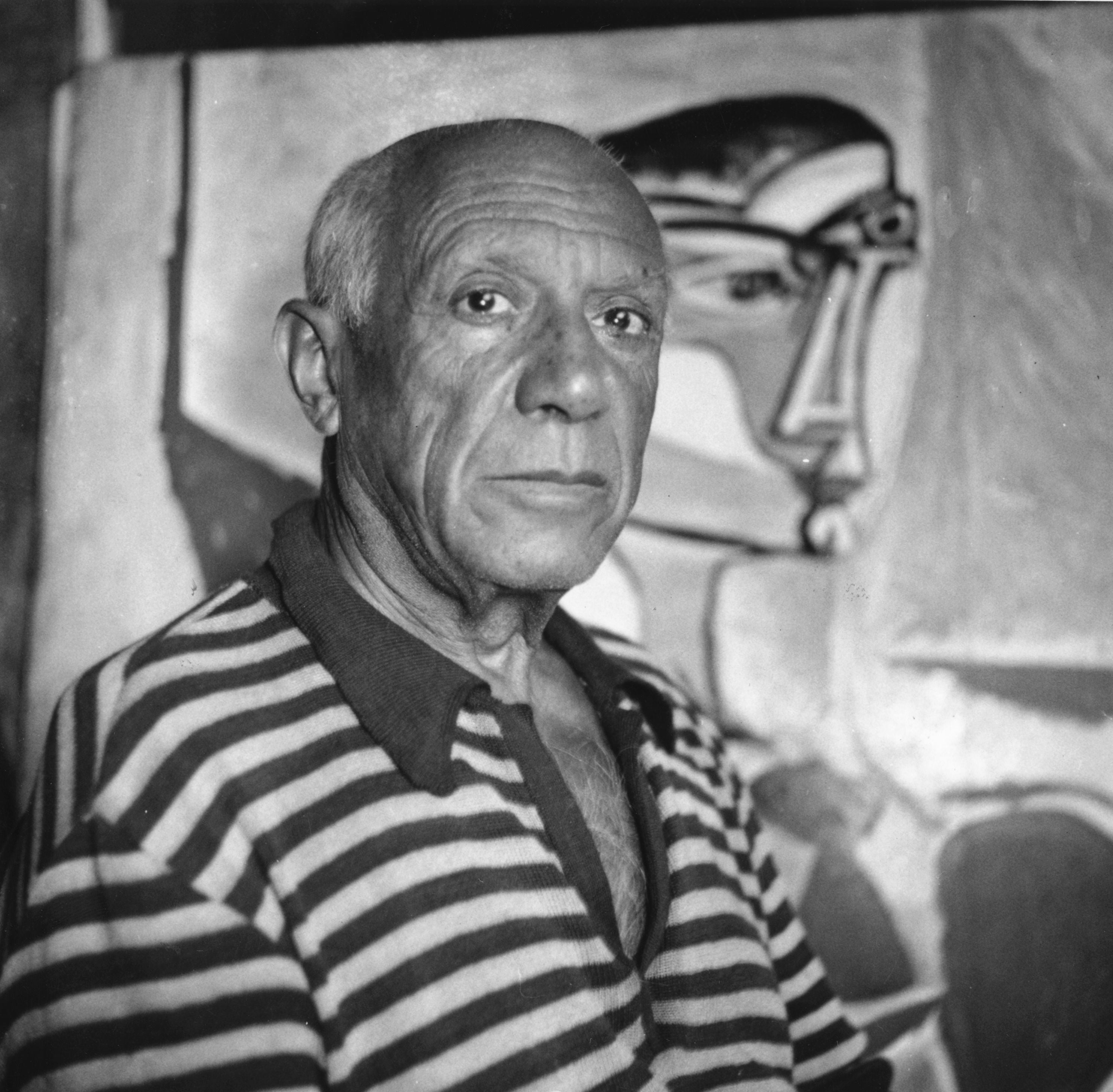 Picasso, who died in 1973, pictured with one of his paintings at his home in Cannes