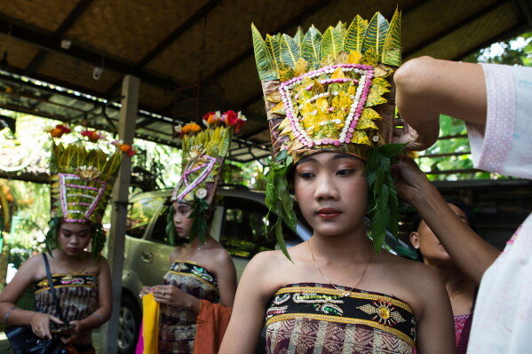 Ketut Alit Widiantary prepares to perform the sacred Rejang dance during Kuningan holiday, which marks the end of the 10-day Galungan festival celebrating the victory of good over evil, in Karangasem, Bali, Indonesia, Saturday, June 27, 2026. (AP Photo/Firdia Lisnawati)