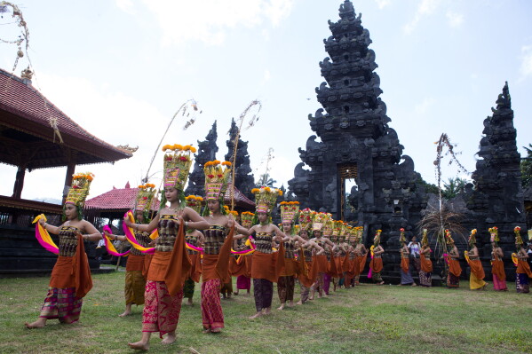 Dancers perform the sacred Rejang dance during Kuningan holiday, which marks the end of the 10-day Galungan festival celebrating the victory of good over evil, in Karangasem, Bali, Indonesia, Saturday, June 27, 2026. (AP Photo/Firdia Lisnawati)