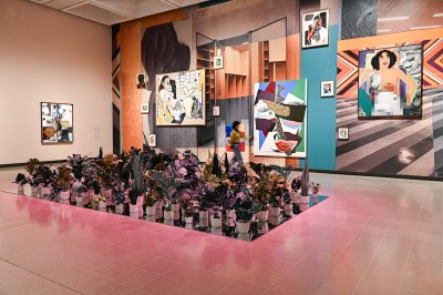 A gallery with paintings laid over a backdrop displaying empty rooms.