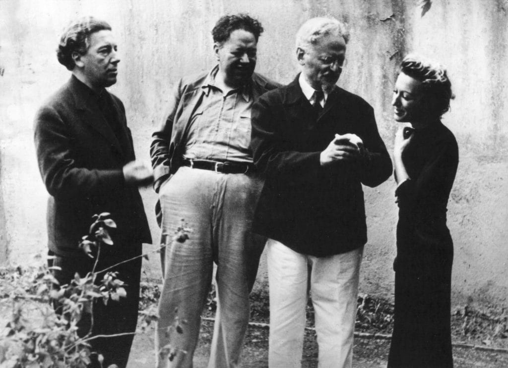 André Breton, Diego Rivera, Leon Trotsky, and Jacqueline Lamba converse together outdoors in Mexico during 1938.