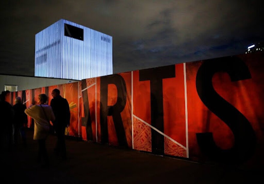 A video projection, "Blue Prints and Perspectives by 3_Search," plays on the exterior of the Dee and Charles Wyly Theatre during Aurora 2013.