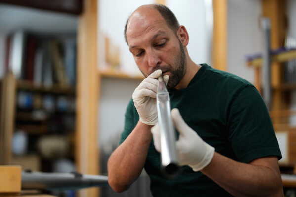 Organ builder Johannes Huefken works on organ pipe for the John Cage organ project at his work shop in Halberstadt, Germany, July 6, 2026. (AP Photo/Matthias Schrader)