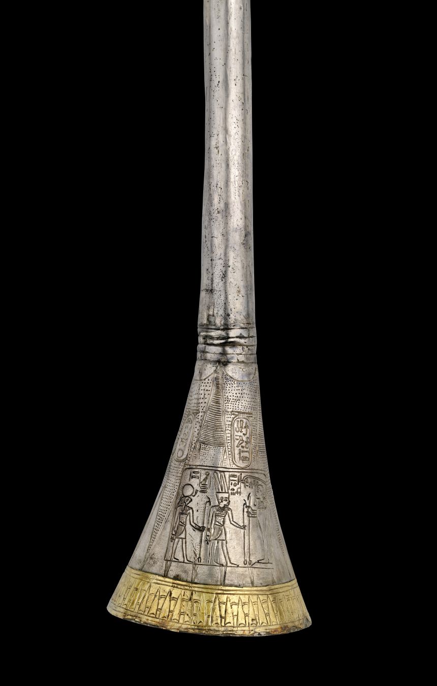 The silver trumpet bears the king's cartouches.