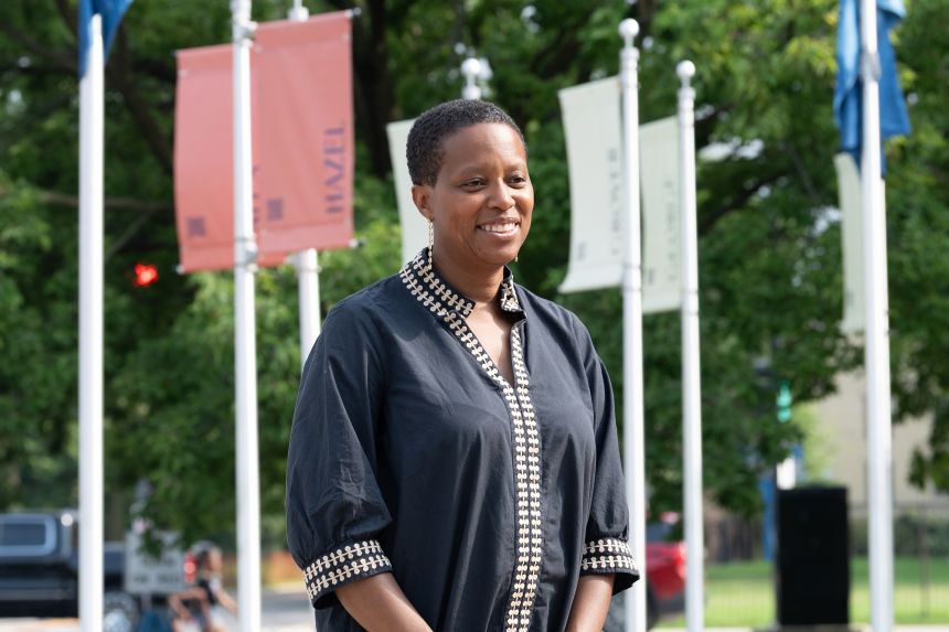 Artist and architect Amanda Williams in front of the banners of “Other Washingtons.”