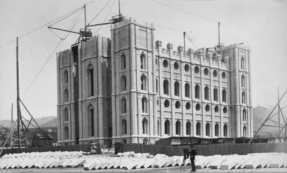 A man stands with an easel before the Salt Lake Temple under construction in 1887. The edifice was completed six years later.