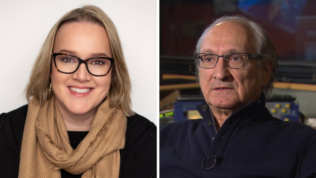 A woman with short blonde hair smiles at the camera on the left and on the right is a man wearing a blue sweater.