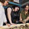 Canadian Museum of Nature researchers Natalia Rybczynski (left), Danielle Fraser and Marisa Gilbert examine the bones of Epiaceratherium itjilik.