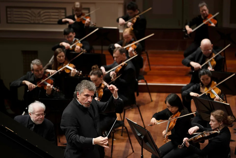 Nashville Symphony conductor Giancarlo Guerrero, front, is directing his orchestra during a performance before a packed Schermerhorn Symphony Center audience on Jan. 9, 2025.