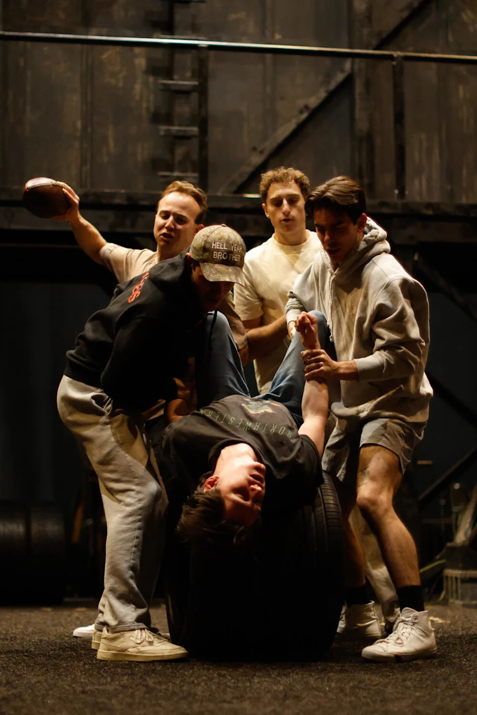 Actors rehearse fight choreography on a stage.
