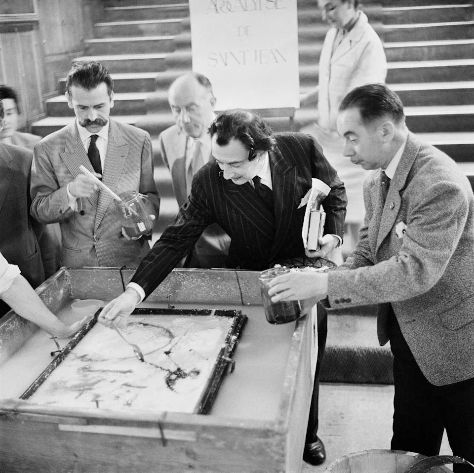 Dali and artist colleagues work on the cover