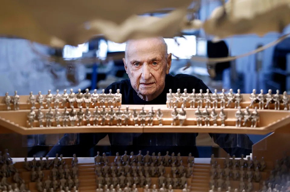Frank Gehry looks at a model.