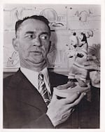 In this undated press image, Pinto Colvig poses with a figurine of Goofy, one of Colvig's many character voices.