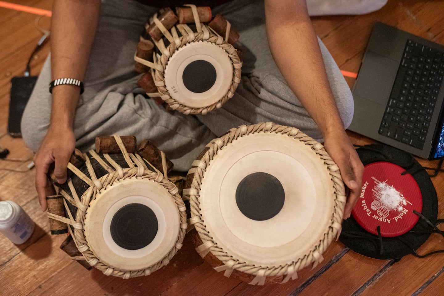 Om Hegde sits with three tabla drums at a rehearsal for the show "The Sitayana, or How to Make an Exit."