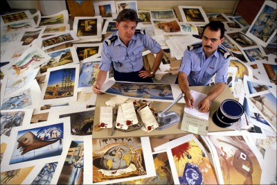 French gendarmes Roumegoux and Roumier, shown in their office with forged Salvador Dali lithographs, France, June 1988.