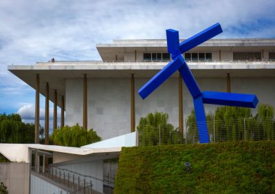 A view of the Link, lower left, a covered pathway that connects the original building and plaza to the REACH, a new multi use complex at the Kennedy Center in Washington, DC. The sculpture is by Joel Shapiro.