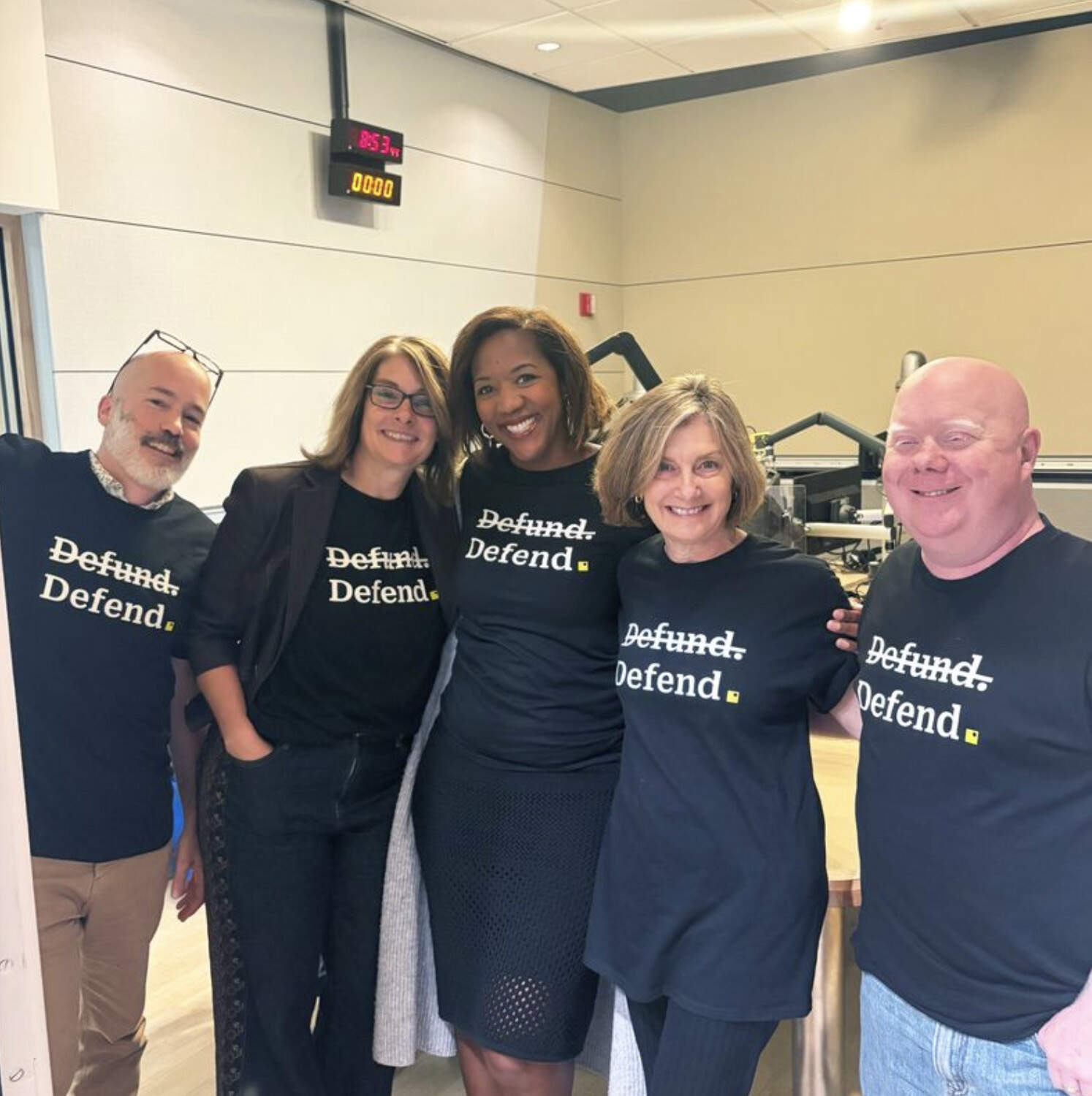Margaret Low, second from right, takes a photo with several WBUR colleagues during a station fundraiser after federal funding was eliminated. (WBUR file photo)