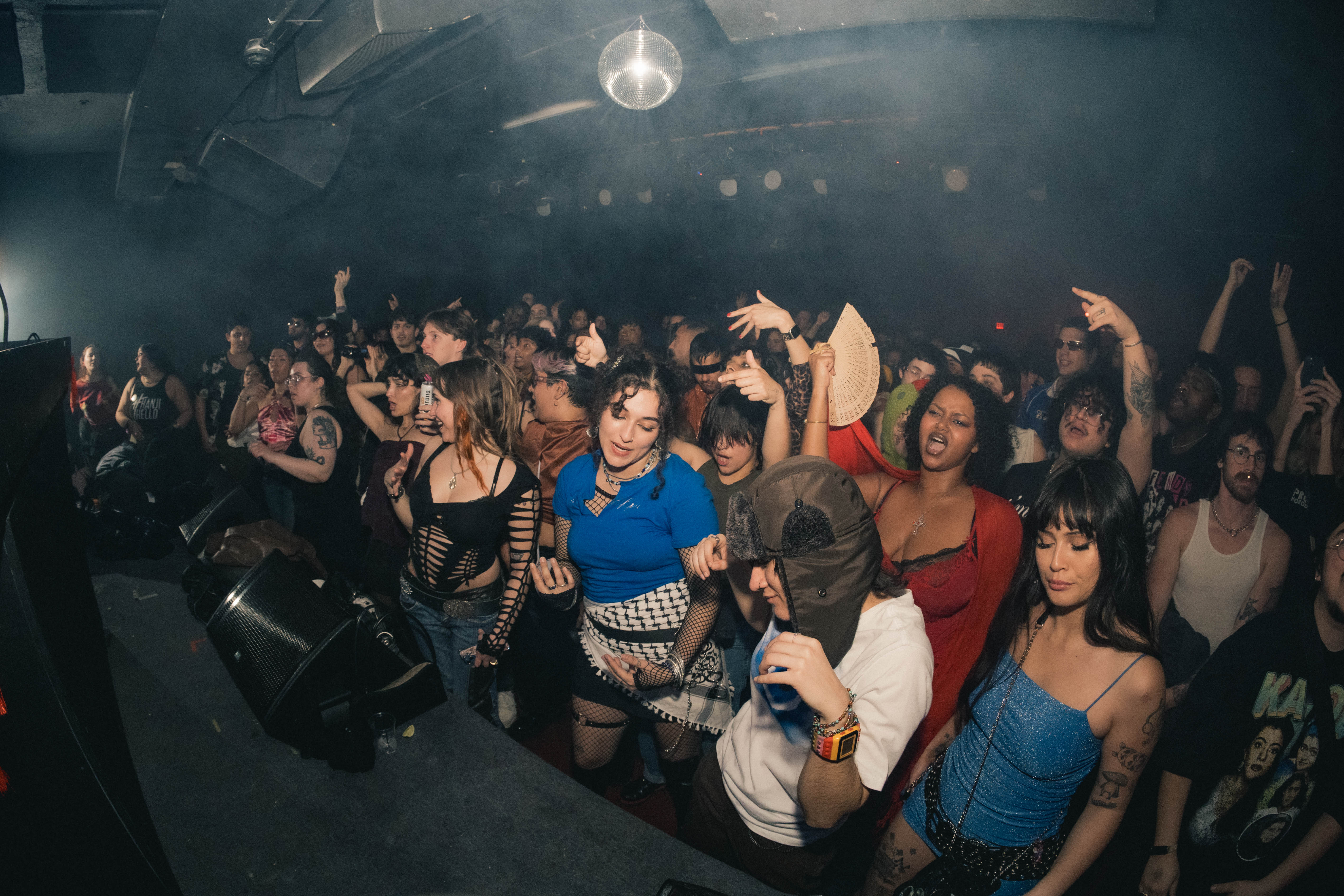 Dancers revel in front of a stage at the Transmission club.